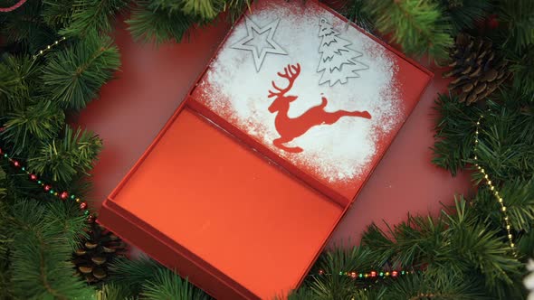 Woman Decorating Giftbox With Powdered Sugar and Figures, Hand-Made Presents