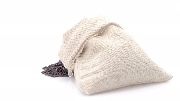 Rotation shot of Black rice berry in bag on white background,Close up.