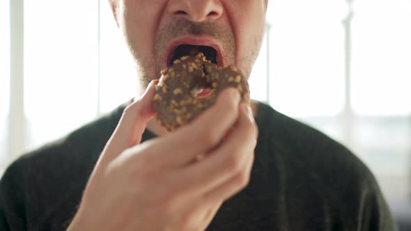 Man Eating Sweet Chocolate Donut