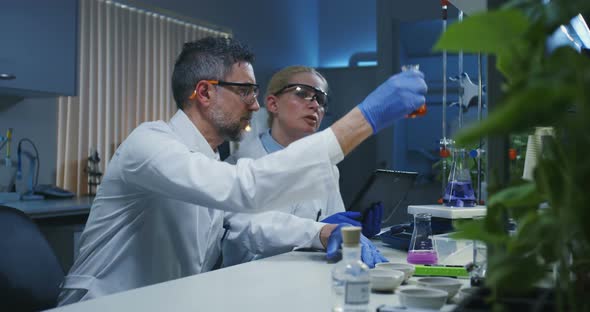 Scientists Examining Various Liquids