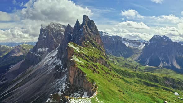 Seceda in Dolomites with blue sky and green hills