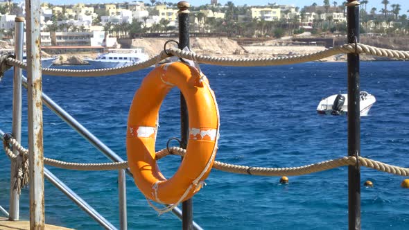 Safety Equipment Life Buoy or Rescue Buoy on the Wooden Pier at the Beach