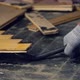 Worker Removes Old Parquet Using a Tire Iron Tool During a Flat Renovation - VideoHive Item for Sale