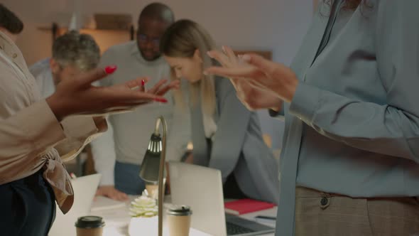 Closeup of Businesswomen Shaking Hands After Negotiations Discussing Deal in Office at Night