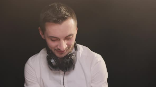 Bearded Dj Standing at the Mixer Controller Composing a New Mix the Party in a Nightclub