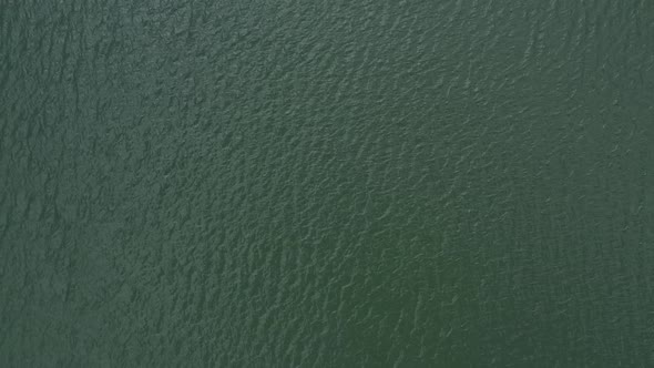 Aerial view or bird eye perspective showing ocean water while ascending up to 400 meters