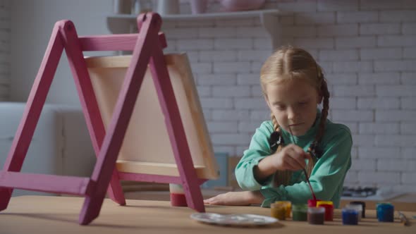 Creative Child Writing Painting on Easel at Kitchen