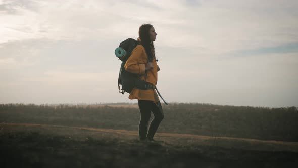 Woman Traveler with Backpack Walking in the Mountains Freedom and Happiness