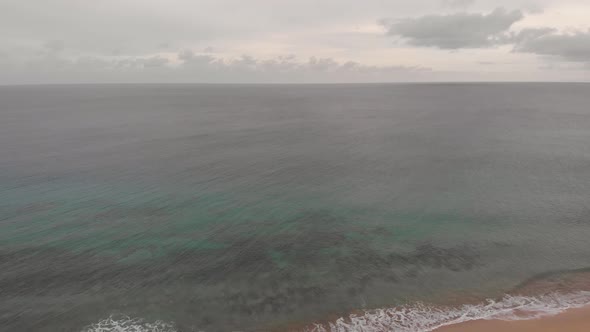 Aerial reverse shot over empty Matadouro beach, Portugal