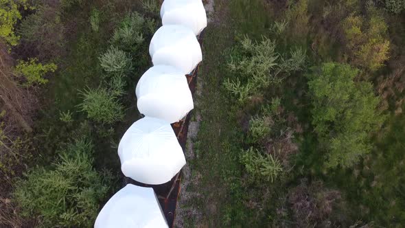 Wind Turbine Nacelle And Hub Ready For Transporting On The Train In Monroe, Michigan - top-down dron