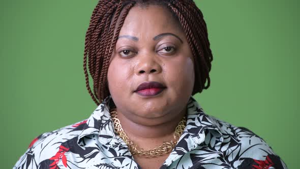 Overweight Beautiful African Woman Against Green Background