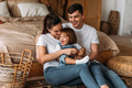 Portrait of a happy young family. Happy family mother, father, little daughter - PhotoDune Item for Sale