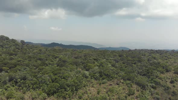 Lush green south-easterner landscape of Bokor Mountains in Kampot, Cambodia - Aerial Panoramic shot