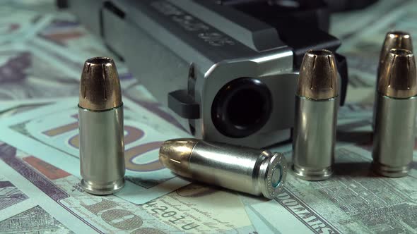 Gun And Bullets On Hundred Dollar Bills