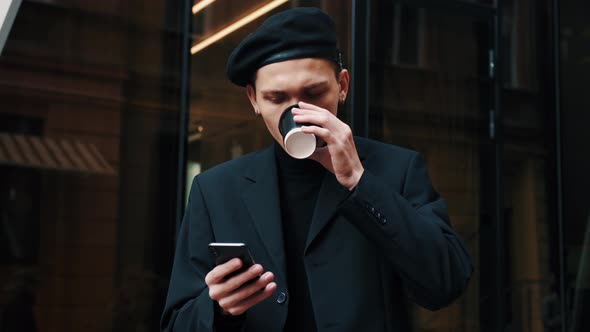 Smart Casual Dressed Office Worker Is Drinking Coffe at the Break. Attractive Man Is Standing Near