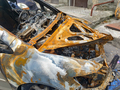 Closeup of burnt car on the city street arsoned by vandals - PhotoDune Item for Sale