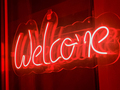 Closeup of red neon Welcome sign on the restaurant or night club door - PhotoDune Item for Sale
