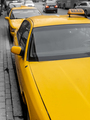 Taxi parking on the city street. Classic yellow taxi cars in New York - PhotoDune Item for Sale