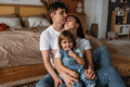 A happy young family spends time together in a home interior - PhotoDune Item for Sale
