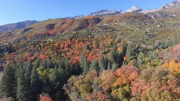 A drone flies over the rocks and slopes of  Dry Creek Trailhead in Alpine, Utah as leaves change int