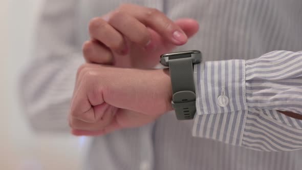 Close Up of Hands of African Woman Using Smartwatch