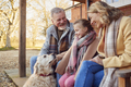 Grandparents With Granddaughter And Pet Dog Outside House Getting Ready To Go For Winter Walk - PhotoDune Item for Sale