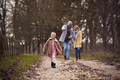 Grandparents With Granddaughter Outside Walking Through Winter Countryside - PhotoDune Item for Sale