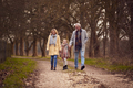 Grandparents With Granddaughter Outside Walking Through Winter Countryside Holding Hands - PhotoDune Item for Sale