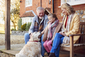 Grandparents With Granddaughter And Pet Dog Outside House Getting Ready To Go For Winter Walk - PhotoDune Item for Sale