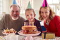 Portrait Of Grandparents With Granddaughter Celebrating Birthday With Party At Home Together - PhotoDune Item for Sale