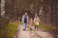 Grandparents With Granddaughter Outside Walking Through Winter Countryside Holding Hands - PhotoDune Item for Sale