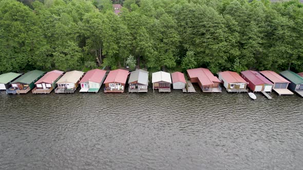 Aerial view of huts by the lakeside forest of Lake Mirow in Germany.