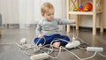 Little baby boy left alone playing with electric cables and wires. - PhotoDune Item for Sale