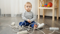 Little baby boy playing with electric plugs and wires at home - PhotoDune Item for Sale