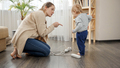 Young caring mother telling her baby son not to play with electricity, wires and cables - PhotoDune Item for Sale