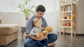 Young father playing with his baby son with teddy bear toy and teaching him - PhotoDune Item for Sale
