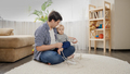 Young caring father teaching his baby son not to touch electric plugs, wires and cables at home. - PhotoDune Item for Sale