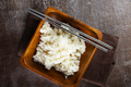 Bowl of boiled rice and sticks on dark table - PhotoDune Item for Sale