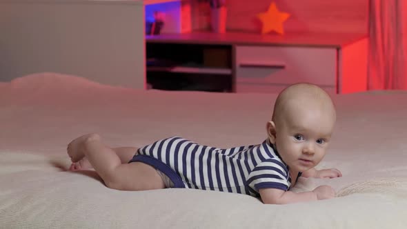 Newborn Playful and energetic child. Toddler baby boy smiles at the camera. 