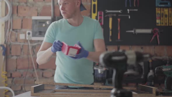 Portrait Skilled Carpenter Cutting a Piece of Wood in His Woodwork Workshop, Using a Circular Saw