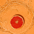 Summer fruit concept citrus red grapefruit on a bright orange background with splashes. - PhotoDune Item for Sale