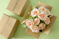 A beautiful blooming bouquet of pink roses in a parcel delivery cardboard box. - PhotoDune Item for Sale