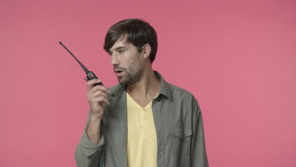 Seriouslooking Confused Young Employee Guy Trying Understand What Person Saying Over Radio Set