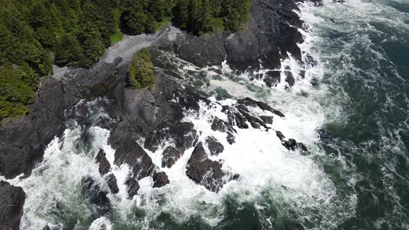 Zenith view of big waves crashing on rocky shore of botany bay from above. Aerial footage of beach o