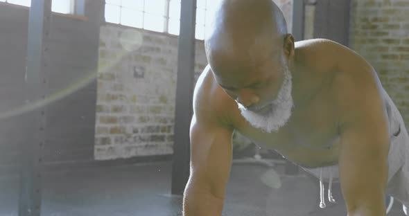 Senior man doing push ups with dumbbells 4k