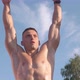 Muscular athletic young man doing pull up on the horizontal bar. Sport and health care concept - VideoHive Item for Sale