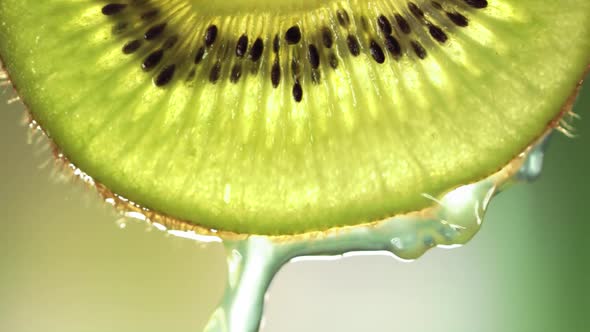 Super Slow Motion Macro Shot of Flowing Water From Kiwi Slice at 1000Fps