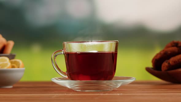 Red Fruit Tea in Glass Cup on a Wooden Table