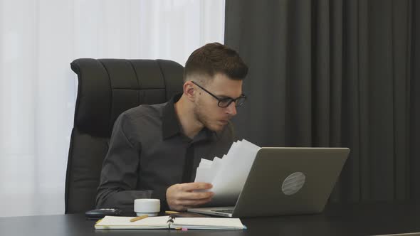 Man looking at financial report of company in office. Corporate office concept