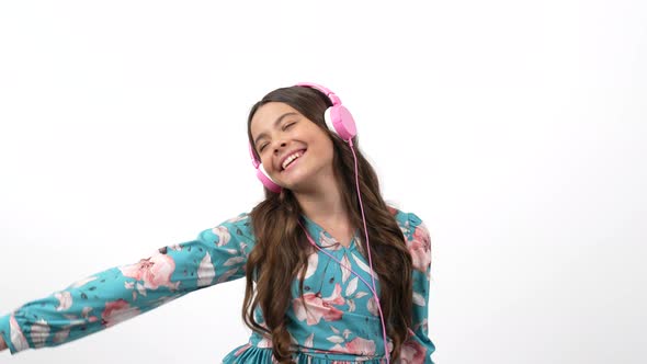 Happy Dancing Child Choose Song in Playlist on Cell Phone Listening Music in Headphones Music